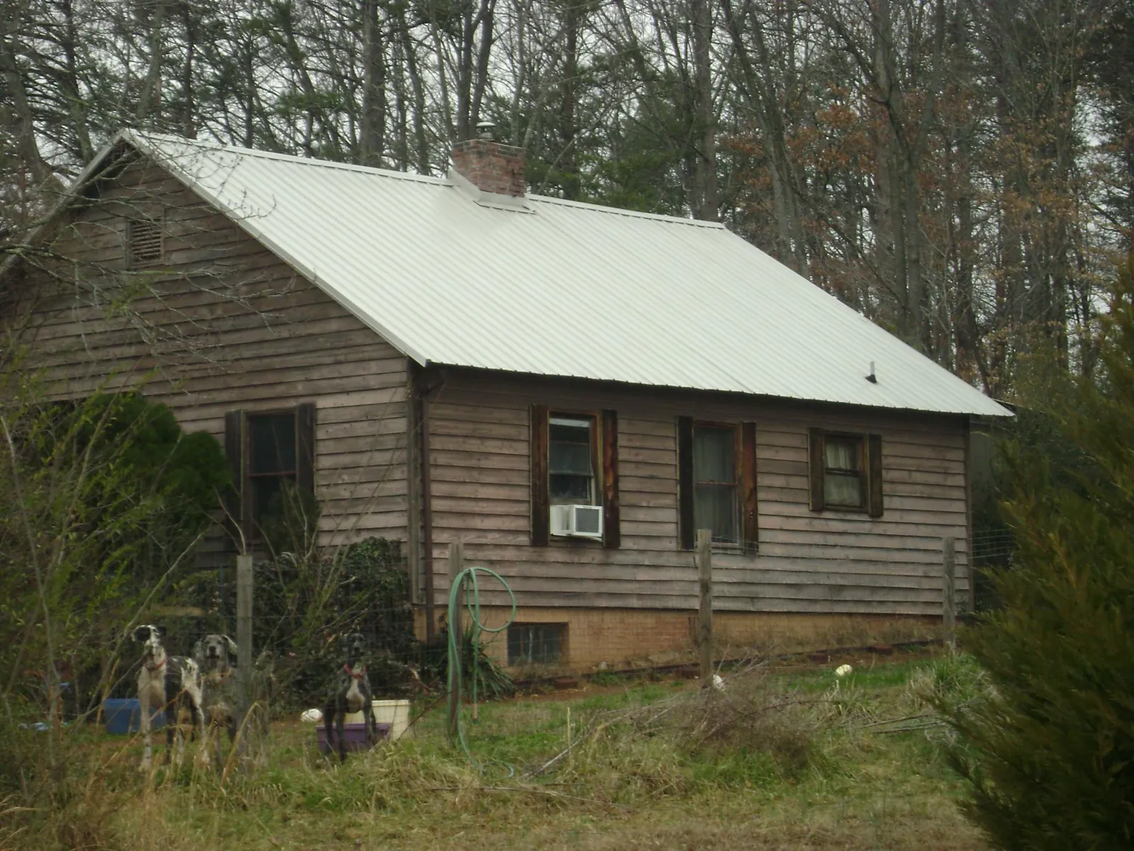 White metal roof on an old wood sided farmhouse, from a Asphalt Shingle Roof Repair job in Wardensville